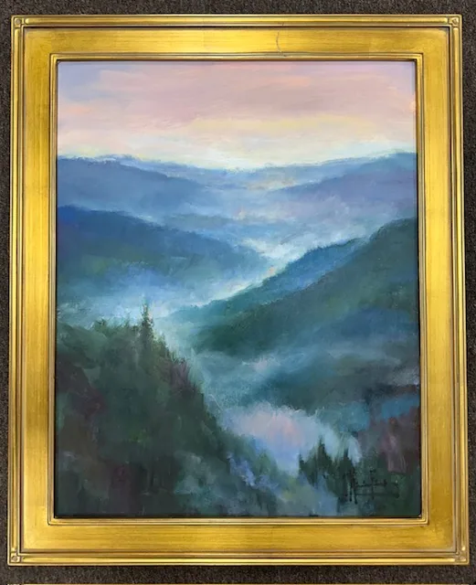 An original oil of misty blue mountain ridges in a deep gold frame
