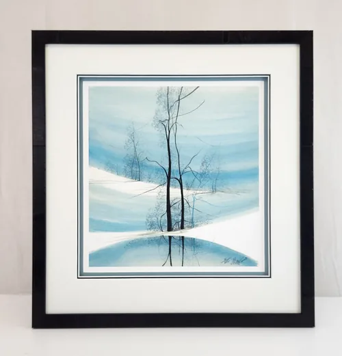 A P. Buckley Moss print of bare blue winter trees, framed in black with a white mat and a thin blue inner mat