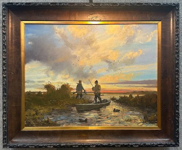 An original oil of duck hunters in a boat at sunrise, in a wide walnut burl frame with a gold inner liner