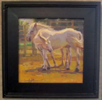 An oil painting of two white horses in a paddock, in a black frame